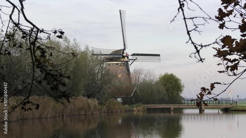 Dutch windmill with small lake in front, Oude Leede, the Netherlands photo