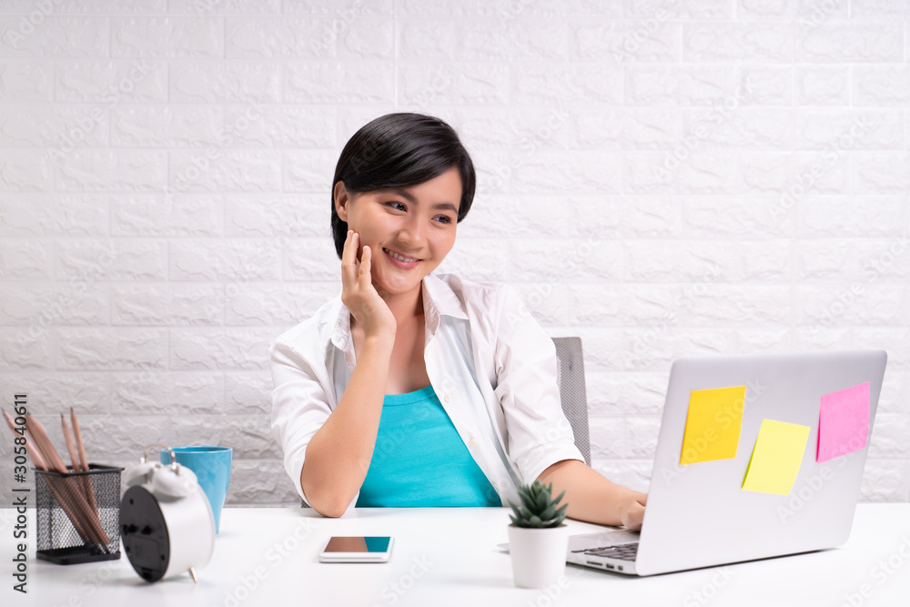 Happy woman sitting at home office working using computer laptop Happy woman sitting at home office working using computer laptop