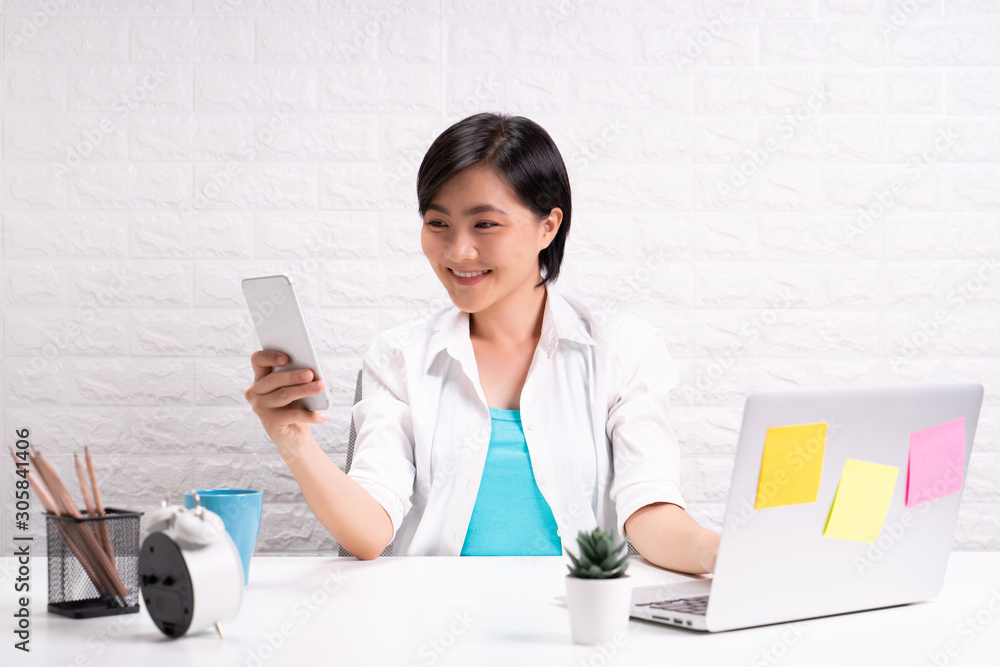 Happy woman use smart phone at office