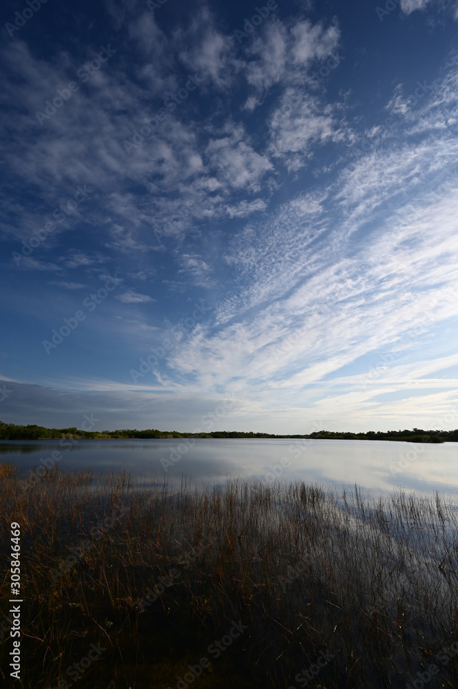Sunrise cloudscape reflected on calm water of Nine Mile Pond in Everglades National Park, Florida. Sunrise cloudscape reflected on calm water of Nine Mile Pond in Everglades National Park, Florida.