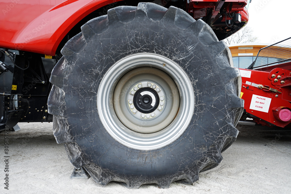 Exterior wheels and tire design of red combine harvester machine Exterior wheels and tire design of red combine harvester machine