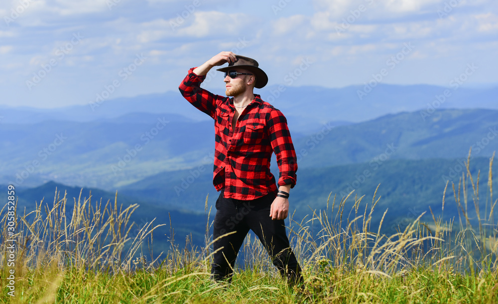 future. cowboy in hat outdoor. man on mountain landscape. camping and hiking. travelling adventure. hipster fashion. countryside concept. farmer on rancho. sexy macho man in checkered shirt future. cowboy in hat outdoor. man on mountain landscape. camping and hiking. travelling adventure. hipster fashion. countryside concept. farmer on rancho. sexy macho man in checkered shirt