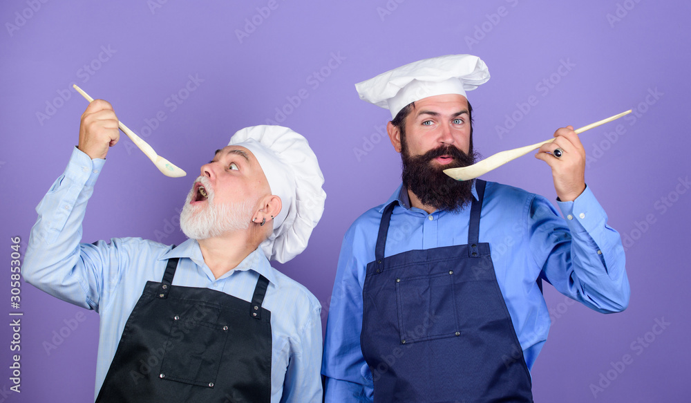 Eat concept. Culinary dynasty. Mature bearded men professional restaurant cooks. Teaching culinary. Culinary book. Delicious recipe. Chef men cooking. Kitchen team prepare food. Family tradition Eat concept. Culinary dynasty. Mature bearded men professional restaurant cooks. Teaching culinary. Culinary book. Delicious recipe. Chef men cooking. Kitchen team prepare food. Family tradition