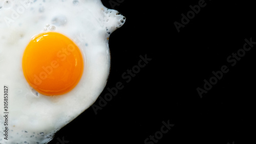 Photos Close up fried eggs on black background,top view