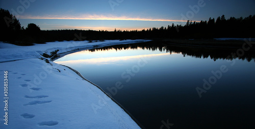 sunset over river in snow