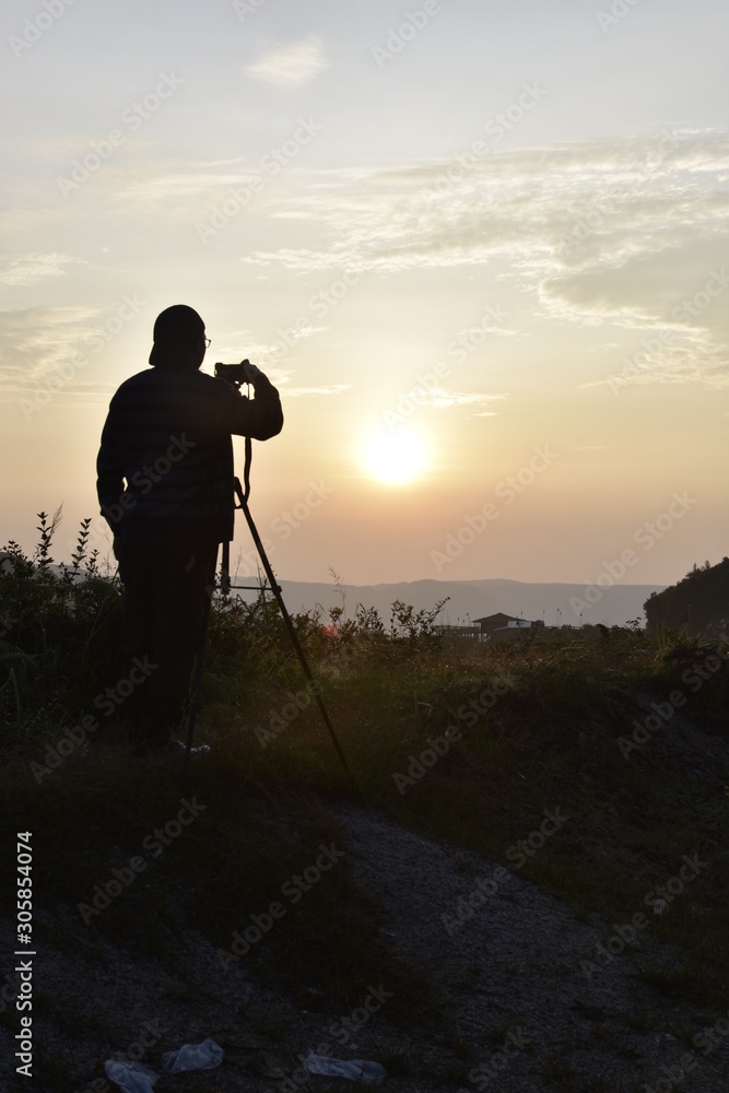 silhouette of photographer at sunrise