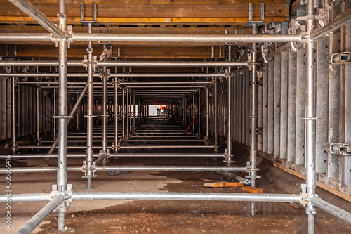 Scaffolding and formwork on concrete walls of the tunnel