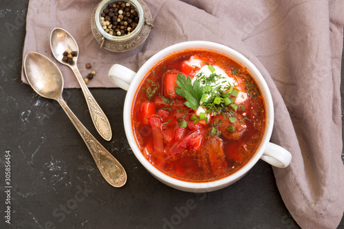 traditional Ukrainian Russian soup (borscht) from beet with greens and sour cream.