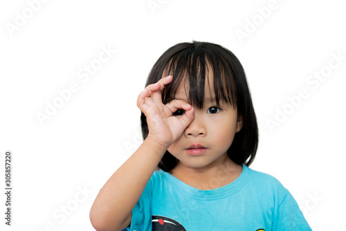 little girl looking through finger