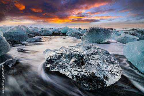 Ice rock with black sand beach at Jokulsarlon beach. Diamond beach in Iceland photo