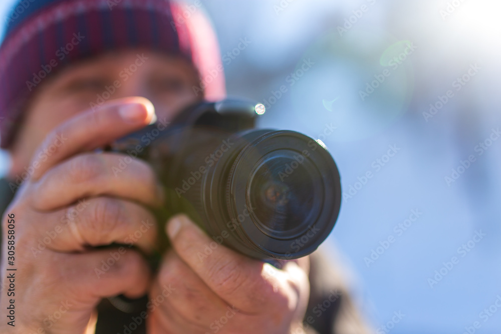 Professional camera in the hands of a man Professional camera in the hands of a man