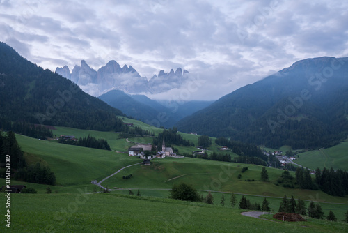 Landscapes with San Giovanni Church and small village in Val di Funes, Dolomite Alps, South Tyrol, Italy, Europe