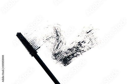 Black smear mascara and brush on white background. Trendy concept. Isolated. Make up. Cosmetic products for eyelashes. Photography. Beauty pattern