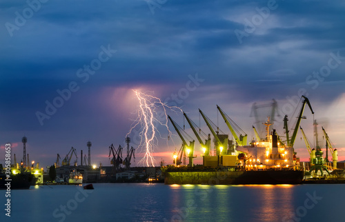 Thunderstorm with lightning over dockyard.