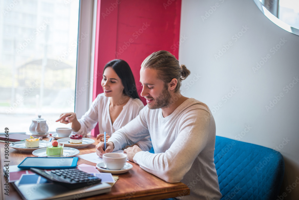 Entrepreneurs having quality check of desserts before opening bakery Entrepreneurs having quality check of desserts before opening bakery