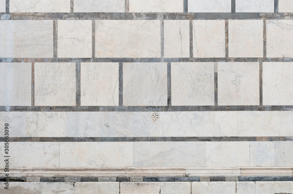 Large marble wall in the side facade of the Carrara cathedral in Tuscany. Large marble wall in the side facade of the Carrara cathedral in Tuscany.