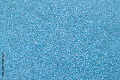 Raindrops blue surface water background