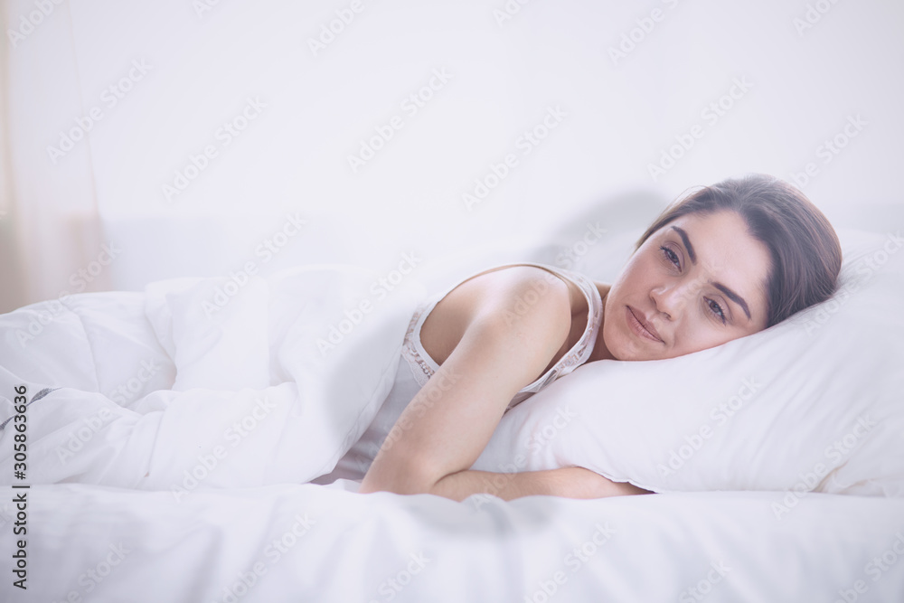 beautiful young woman basking in bed in the morning. Beautiful beautiful young woman basking in bed in the morning. Beautiful