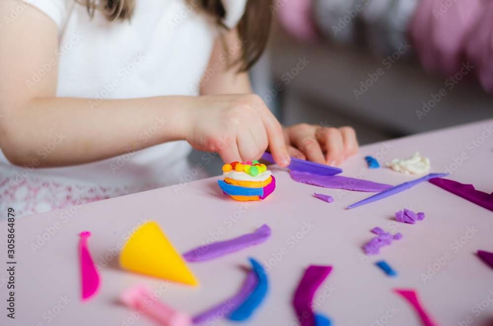 Child hands playing with colorful clay. Homemade plastiline. Girl molding modeling clay. Homemade clay. Child playing and creating from play dough. Child hands playing with colorful clay. Homemade plastiline. Girl molding modeling clay. Homemade clay. Child playing and creating from play dough.