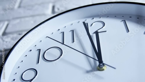 The Clock With The Black Arrow Shows The Time Twelve.