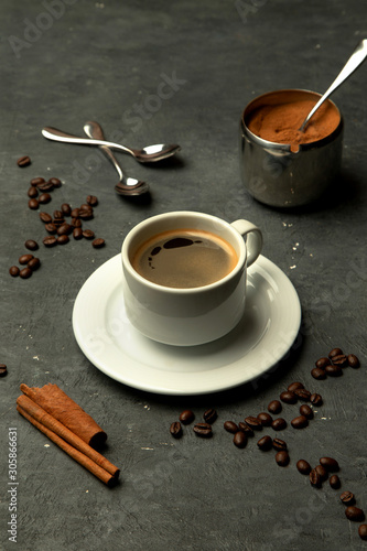 glass of americano coffee in grey background decorated with coffee beans
