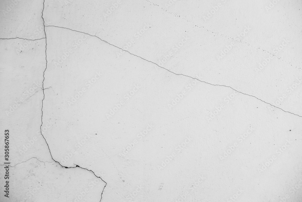 Obraz premium Close-up of White cement wall peeled paint caused by water and sunlight. Peel wall of White house paint with black stain. Black and White of Texture background.