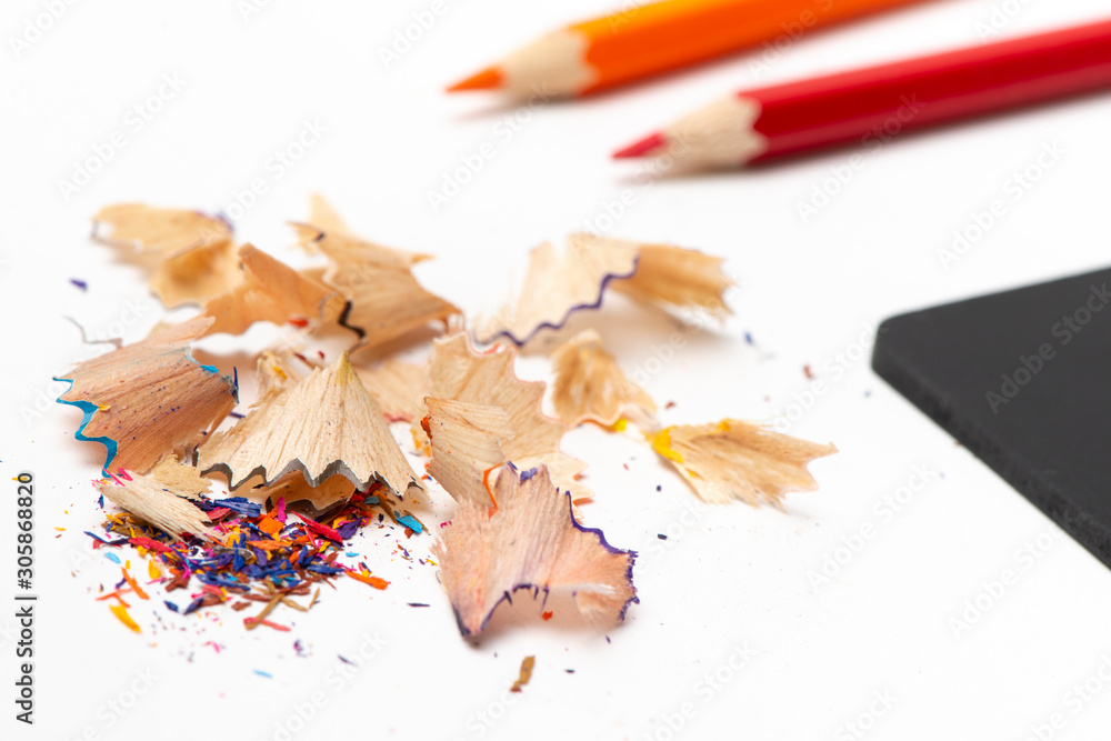 Stationeryset for drawing on white background include crayons, blackboard, sharpener and debris from the sharpening Stationeryset for drawing on white background include crayons, blackboard, sharpener and debris from the sharpening