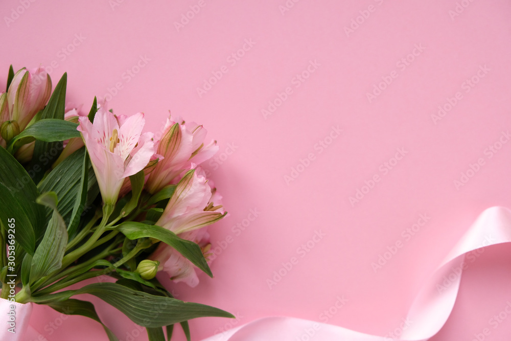 Frame with pink flowers and pink ribbon on pink background. Frame with pink flowers and pink ribbon on pink background.