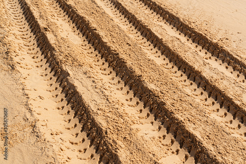 Car tire marks in the sand. car tracks. desert. more sand photo