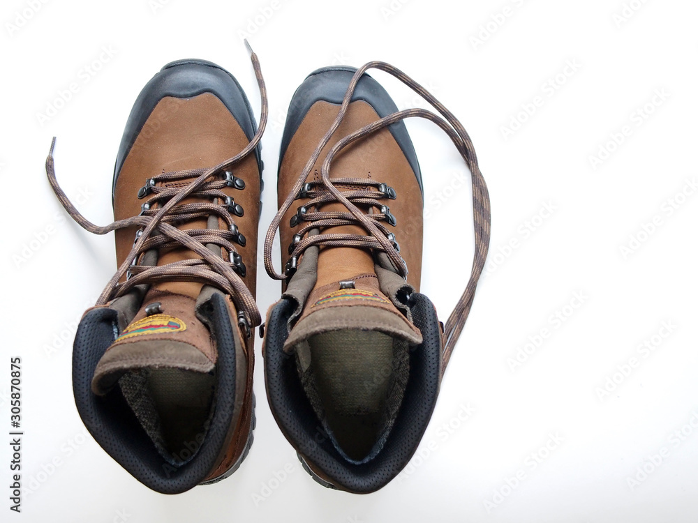 A pair of new trekking boots, top view on a white background with a blank space for text.