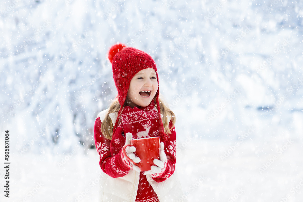 Child drinking chocolate on Christmas in snow Child drinking chocolate on Christmas in snow