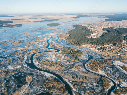 Winter landscape on a winding river in ice. Aerial view