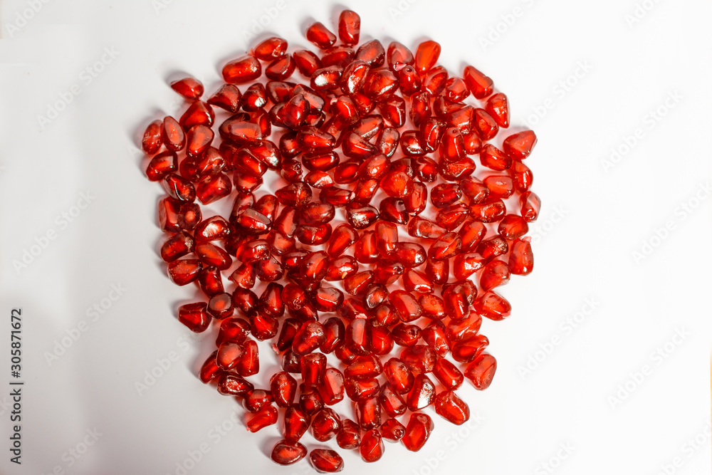 Pomegranate fruit seeds isolated on white macro background Pomegranate fruit seeds isolated on white macro background
