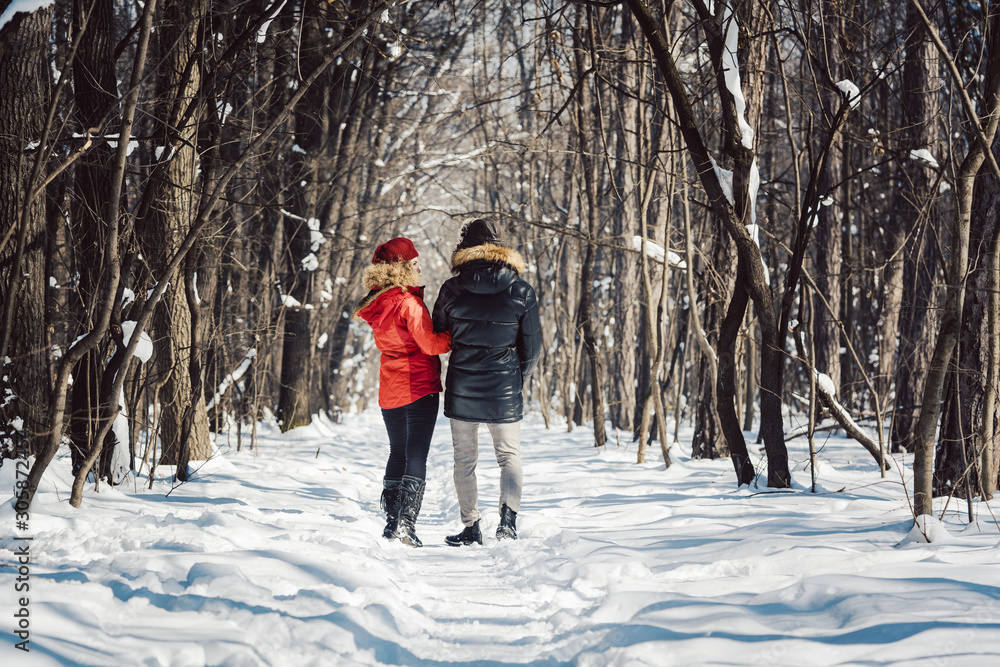 Woman and man enjoying winter in the snow