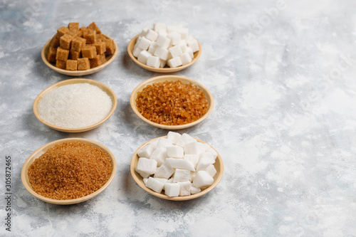 Various types of sugar, brown sugar and white on concrete background,top view