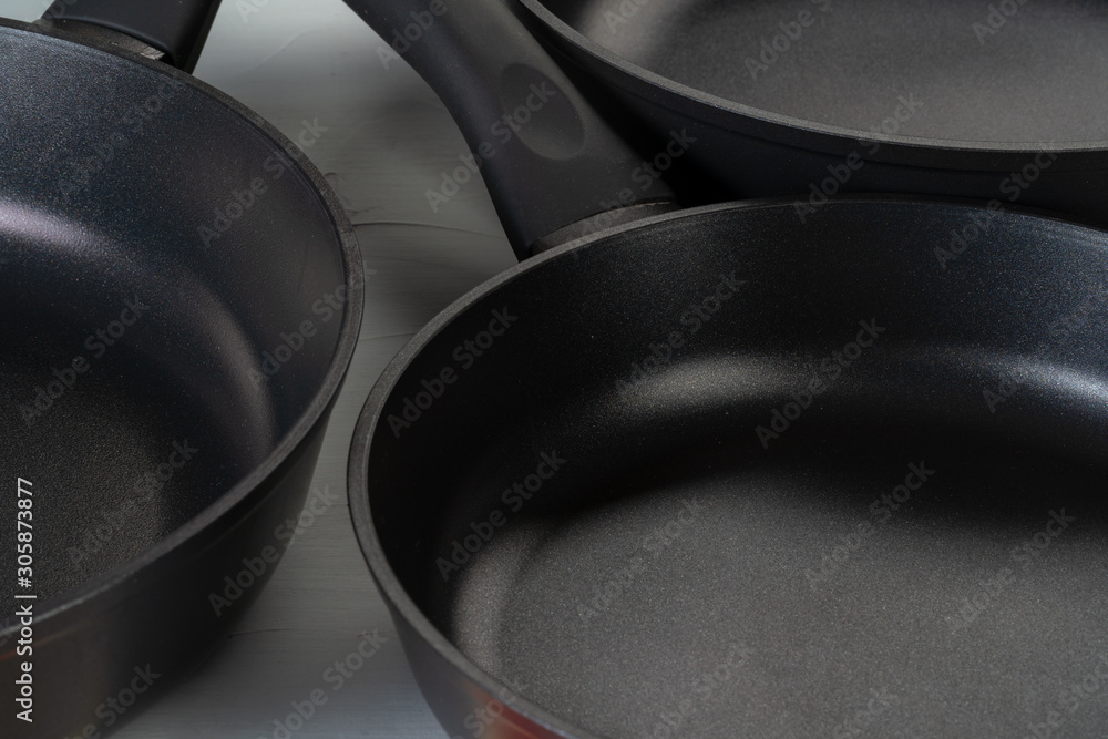 Clean and dry cooking pans on a kitchen counter Clean and dry cooking pans on a kitchen counter
