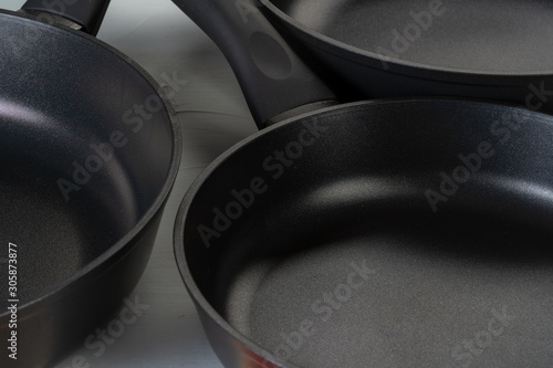 Clean and dry cooking pans on a kitchen counter