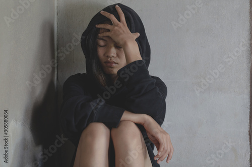  Depressed and hopeless teenage girl sitting alone after using drugs, Drugs addiction and withdrawal symptoms ,  No to drugs concept. International Day against Drug Abuse.