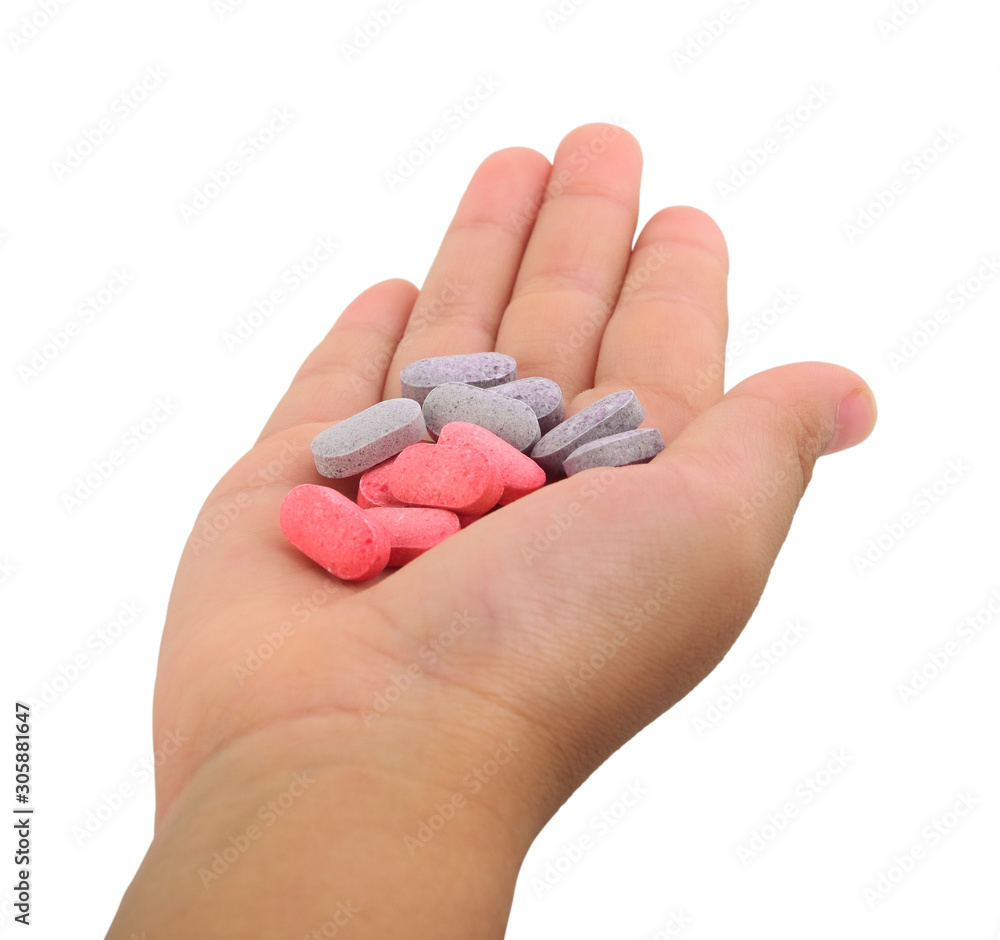multiple colors Vitamin c Red purple pills in hand on white background multiple colors Vitamin c Red purple pills in hand on white background
