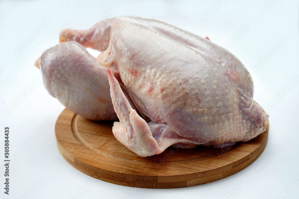 Fresh chicken on cutting Board isolated on light background. Healthy food, proteins Fresh chicken on cutting Board isolated on light background. Healthy food, proteins