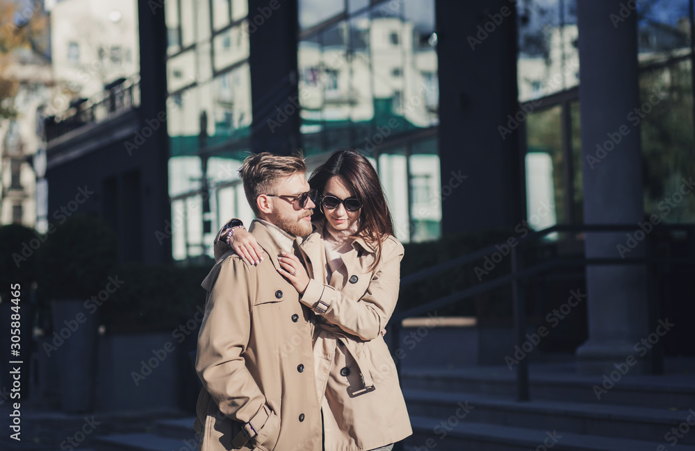 two lovers in the city. happy young couple walking down the street on autumn day
