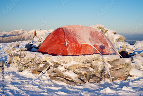 Red tourist ten in frosty weather in mountains photo