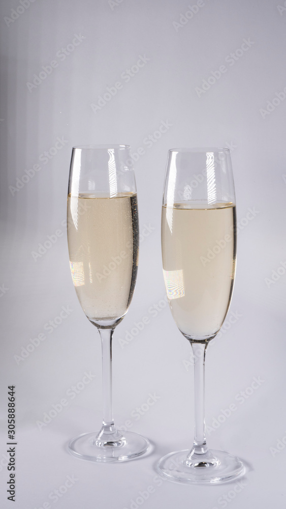 Two glasses with champagne on a white background