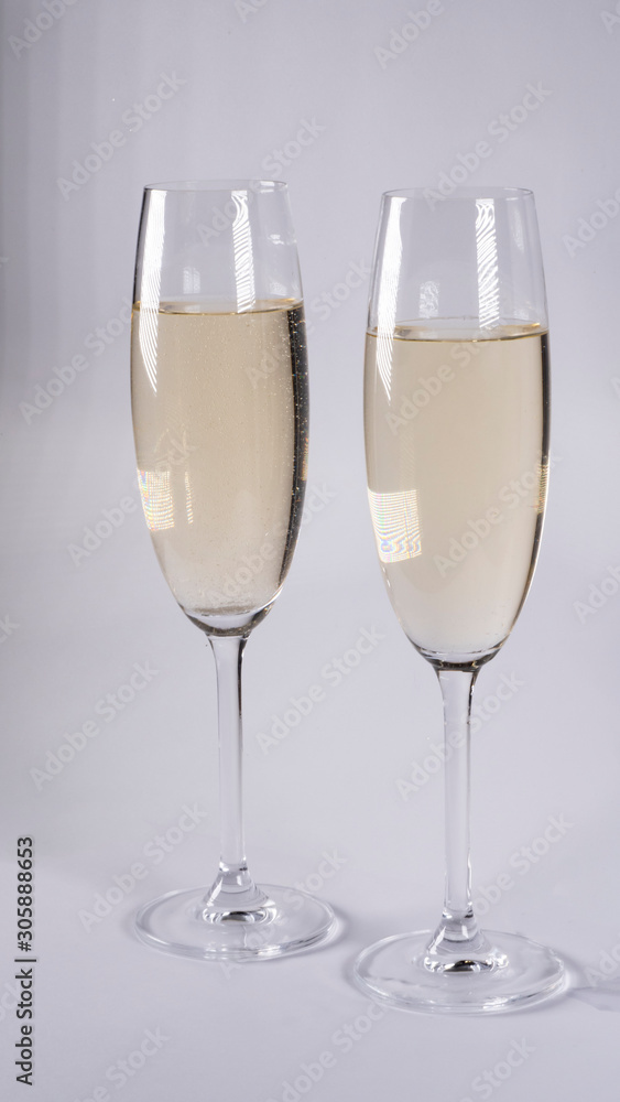 Two glasses with champagne on a white background Two glasses with champagne on a white background