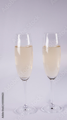 Two glasses with champagne on a white background
