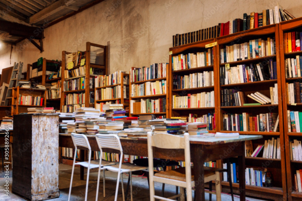 Books in rows on shelves in an old authentic store. Blur Background. Space for text.