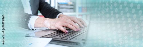 Businesswoman typing on a laptop; panoramic banner