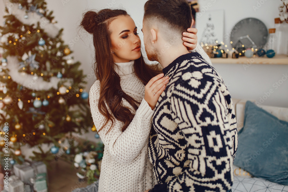 young and pretty couple sitting in a decoration room young and pretty couple sitting in a decoration room