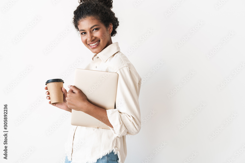Smiling lovely stylish african woman holding laptop computer Smiling lovely stylish african woman holding laptop computer