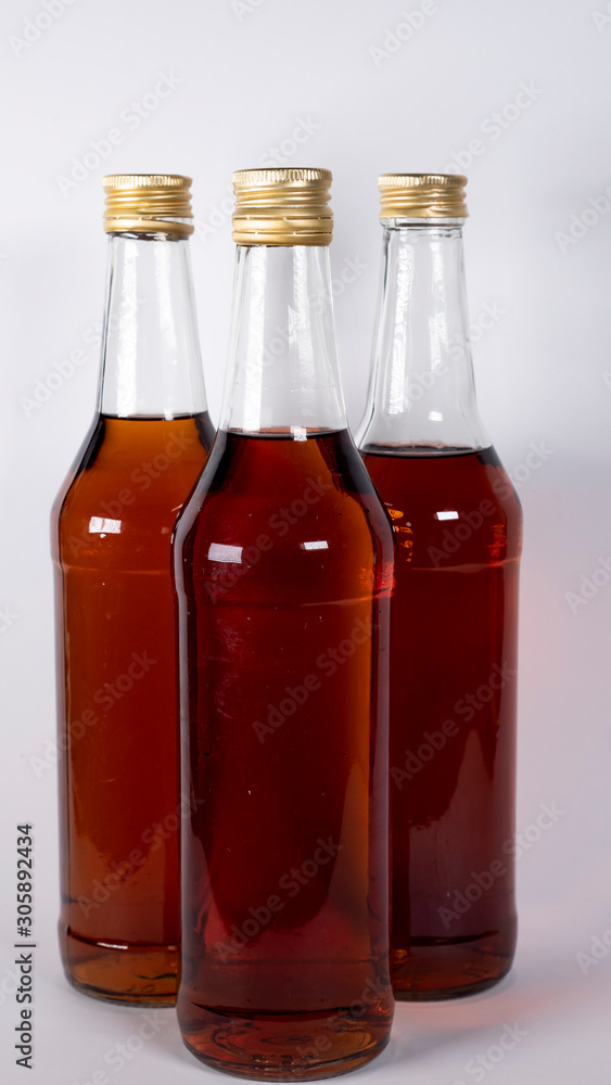 Bottles with cognac, whiskey on a white background Bottles with cognac, whiskey on a white background